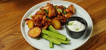 A delectable plate of roast potatoes served with chanterelle mushrooms and fresh cucumbers.